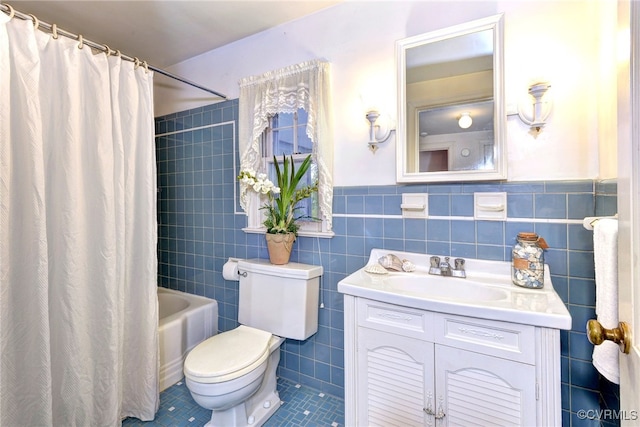 full bathroom with shower / bath combination with curtain, toilet, tile walls, vanity, and tile patterned flooring