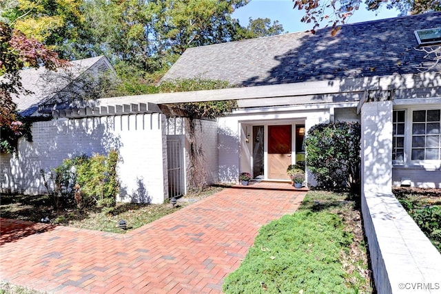 view of exterior entry featuring a patio area