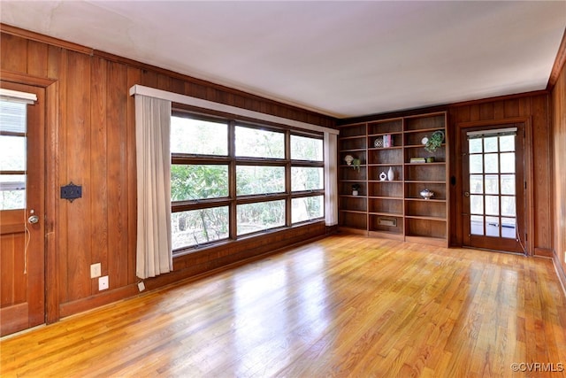 222 W Queens Dr, Williamsburg, VA 23185 - unfurnished room with wood walls, light wood-style flooring, baseboards, and built in shelves