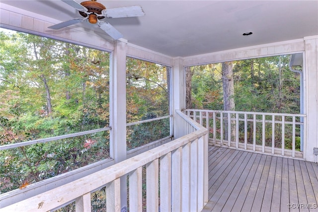 unfurnished sunroom featuring ceiling fan