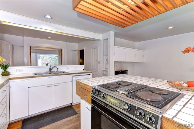 kitchen with tile counters, dark hardwood / wood-style floors, black range with electric cooktop, sink, and white cabinets