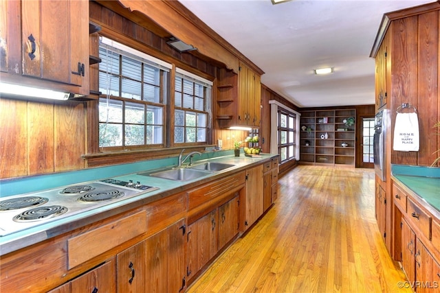 222 W Queens Dr, Williamsburg, VA 23185 - kitchen featuring a sink, stainless steel electric cooktop, light wood-type flooring, brown cabinetry, and built in features