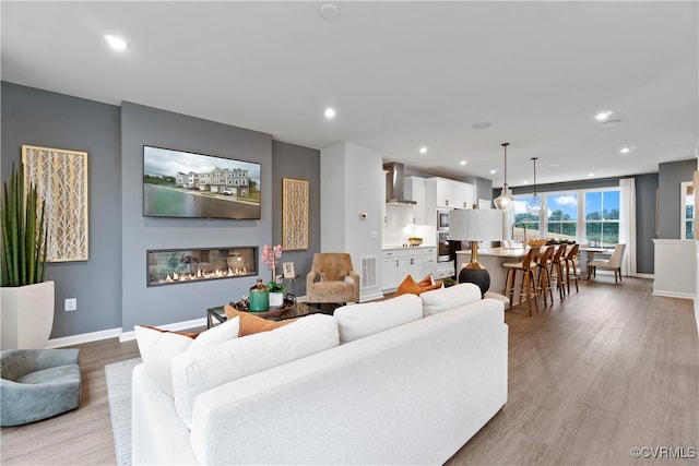 living room with light hardwood / wood-style flooring