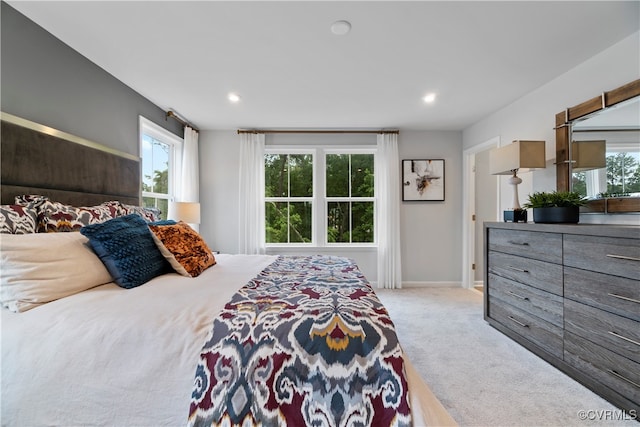 carpeted bedroom featuring multiple windows