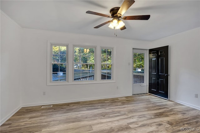 unfurnished room featuring light hardwood / wood-style floors, plenty of natural light, and ceiling fan