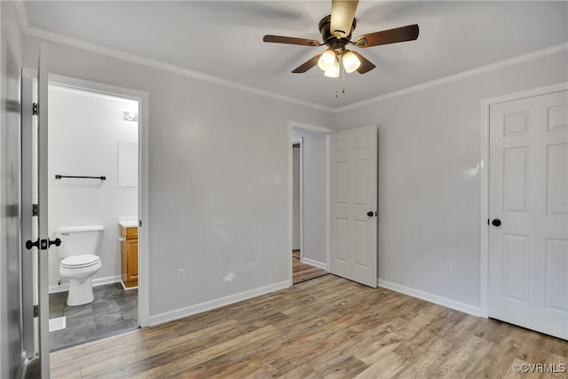 unfurnished bedroom with ornamental molding, ceiling fan, ensuite bathroom, and hardwood / wood-style flooring