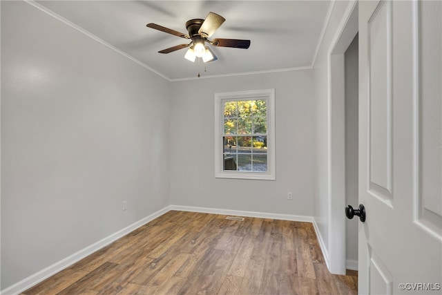 empty room featuring ceiling fan, hardwood / wood-style flooring, and ornamental molding