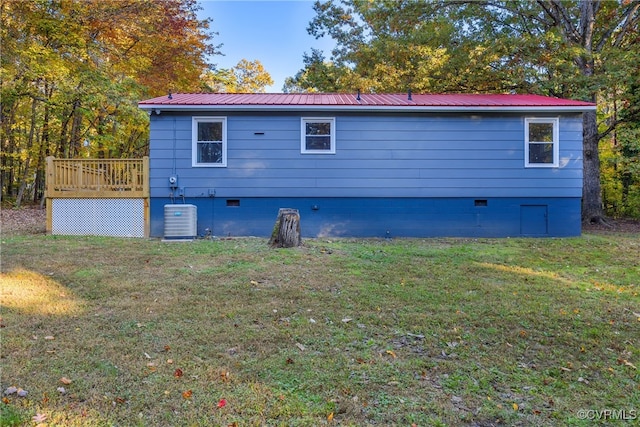 back of house featuring a yard, a deck, and central air condition unit