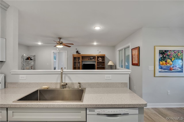 kitchen with ceiling fan, white cabinetry, white dishwasher, light hardwood / wood-style flooring, and sink