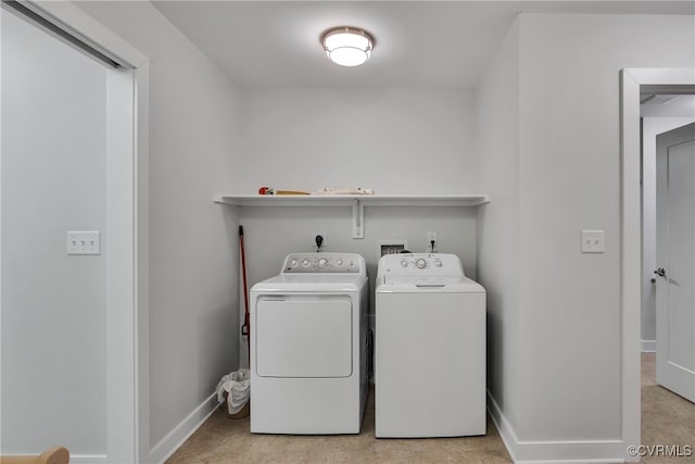 laundry room with independent washer and dryer and light colored carpet