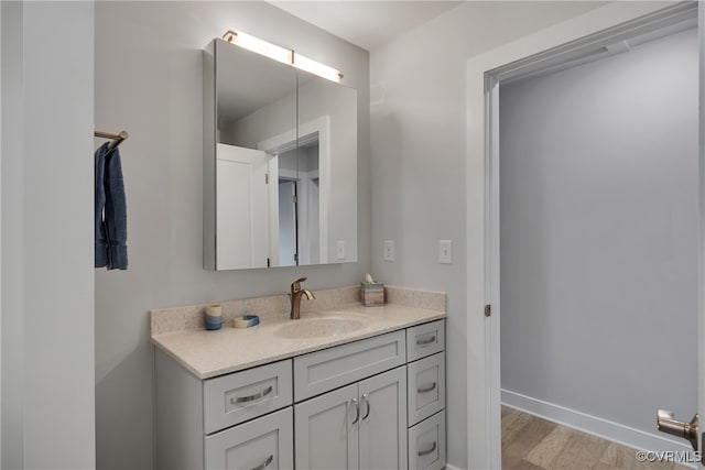 bathroom with vanity and hardwood / wood-style floors