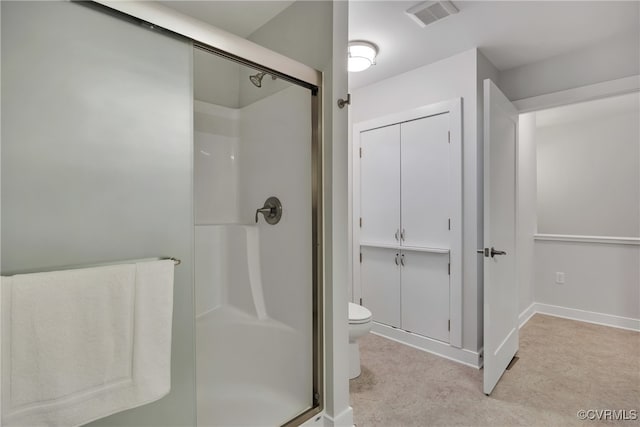 bathroom featuring toilet and an enclosed shower