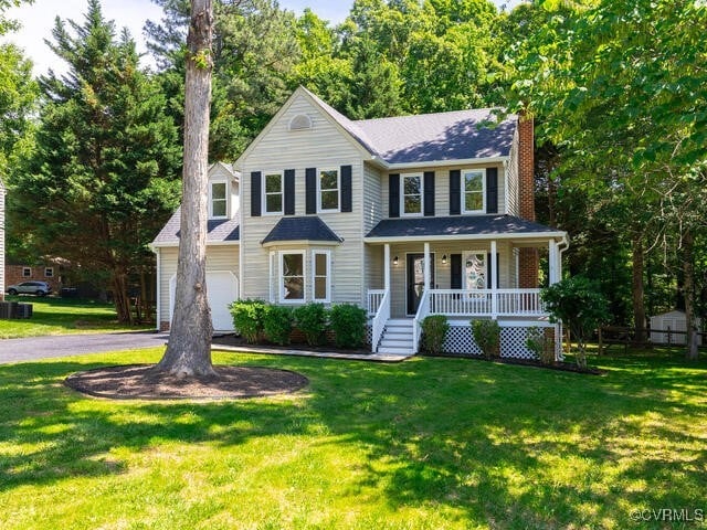 1307 Pritchard Ter, Chesterfield, VA 23235 - view of front facade featuring covered porch, a chimney, a front yard, and asphalt driveway