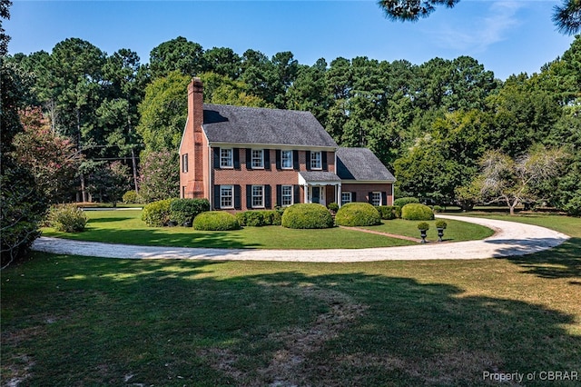 colonial-style house with a front lawn