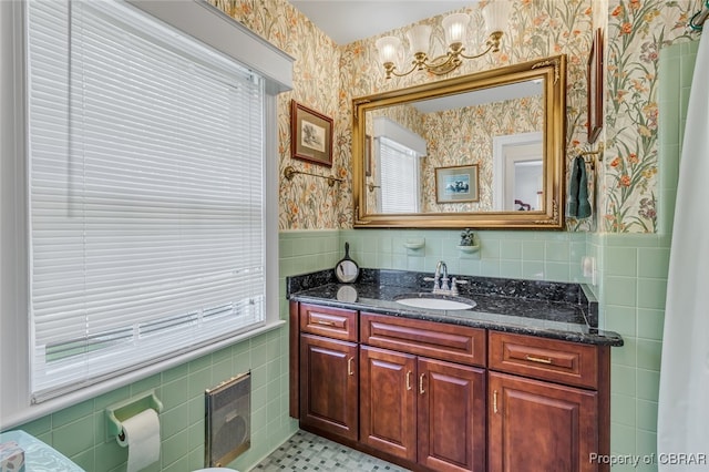 bathroom featuring vanity, plenty of natural light, and tile walls