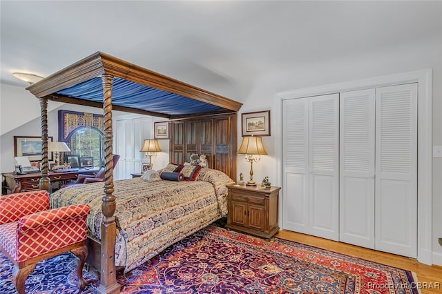 bedroom with a closet and hardwood / wood-style flooring