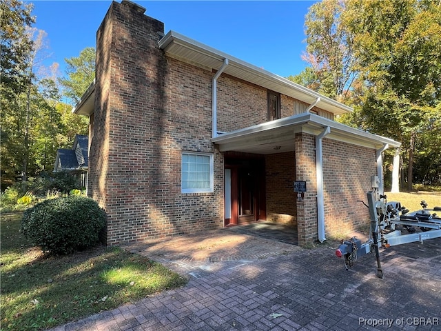 view of side of home with a carport