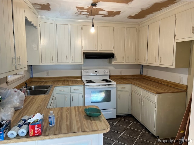 kitchen featuring white cabinets, electric range, pendant lighting, dark tile patterned flooring, and sink