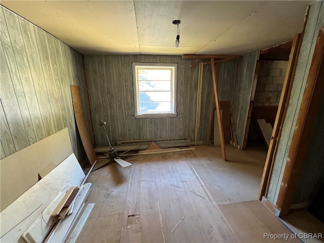 misc room featuring light hardwood / wood-style floors and wood walls