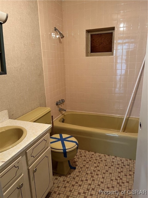 full bathroom featuring vanity, toilet, tile patterned flooring, and tiled shower / bath