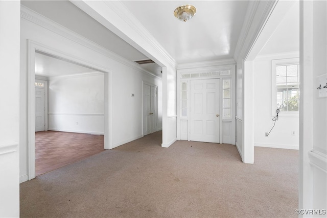 carpeted entrance foyer featuring ornamental molding