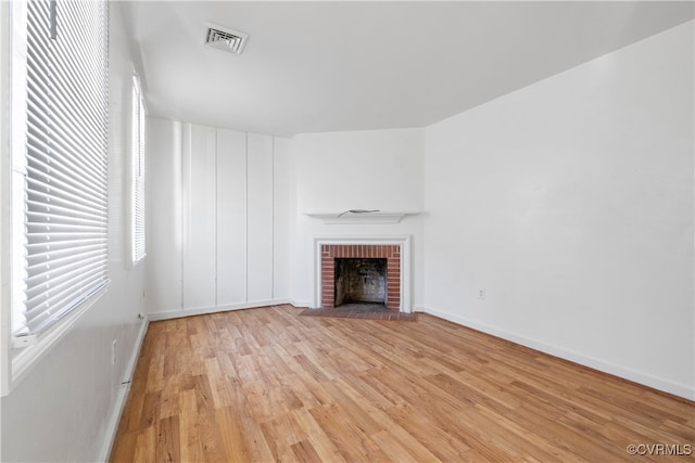 unfurnished living room with light hardwood / wood-style flooring and a fireplace