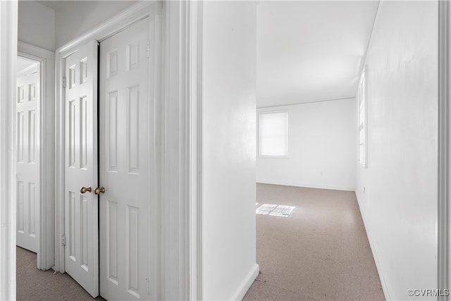 hallway with light colored carpet