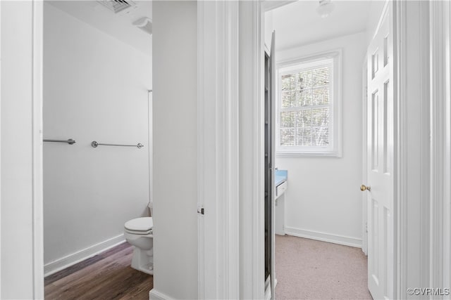 bathroom with wood-type flooring and toilet