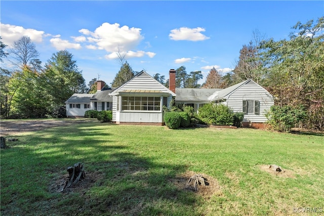 view of front of house featuring a front lawn and a sunroom