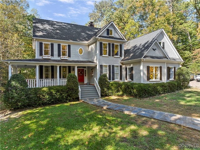 view of front of property with a front yard and a porch