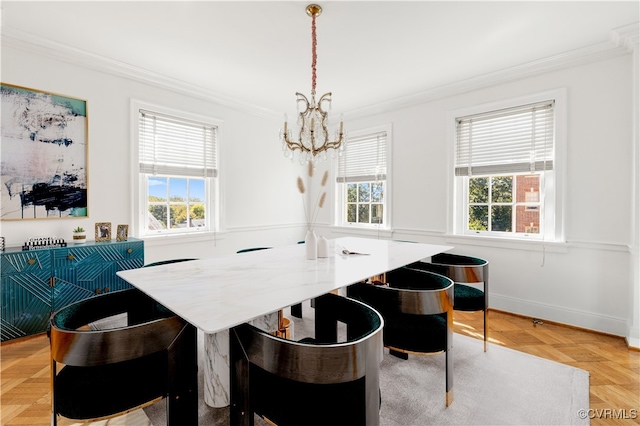 dining space featuring light parquet flooring, an inviting chandelier, and crown molding