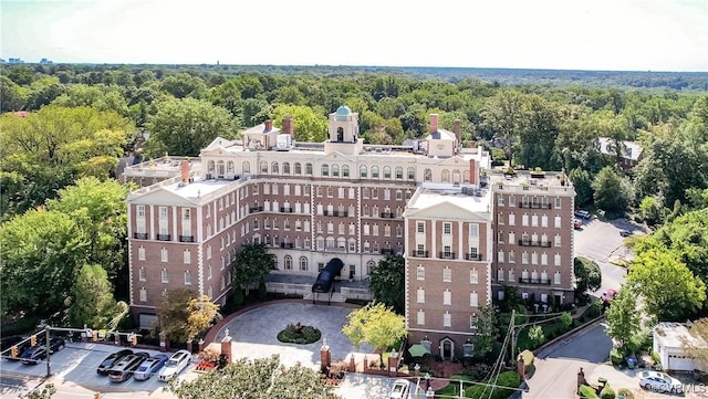 birds eye view of property with a view of trees