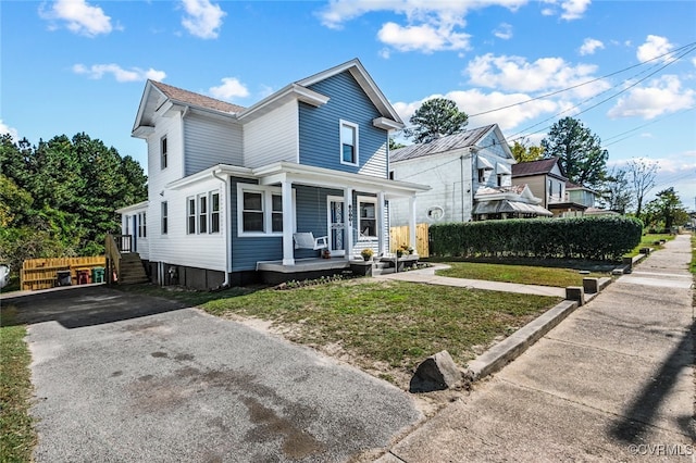 view of front of house with a porch and a front lawn