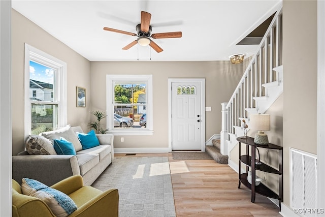 entrance foyer featuring ceiling fan, a healthy amount of sunlight, and light hardwood / wood-style floors