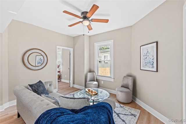 living area featuring light hardwood / wood-style flooring and ceiling fan