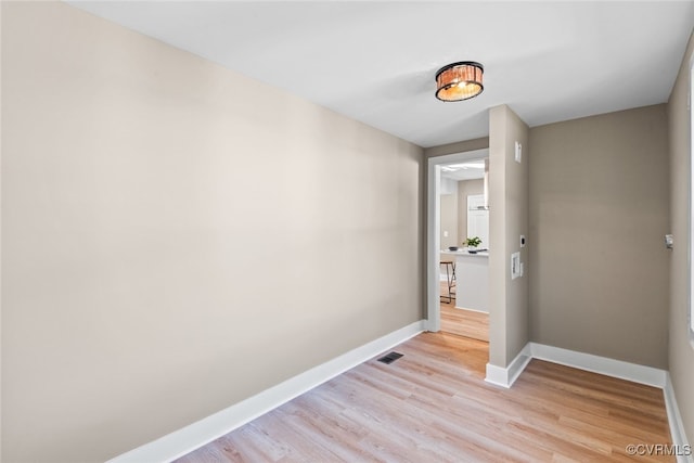 hallway with light hardwood / wood-style flooring