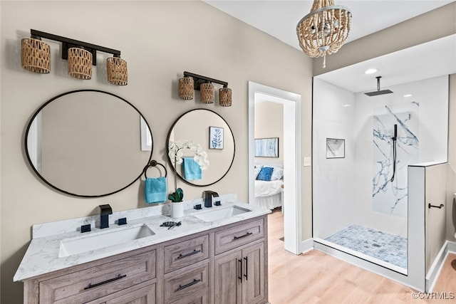 bathroom featuring a shower, wood-type flooring, vanity, and a chandelier