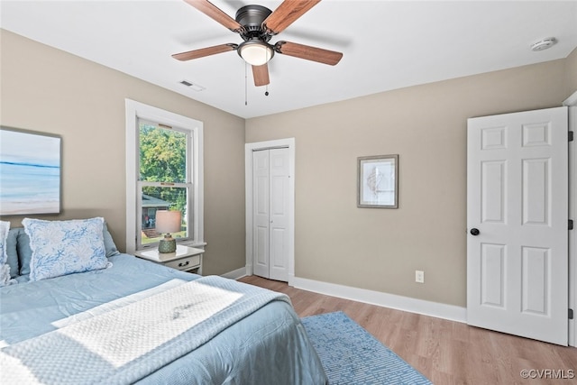 bedroom featuring a closet, light hardwood / wood-style floors, and ceiling fan