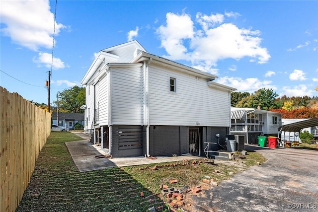 view of property exterior with a carport