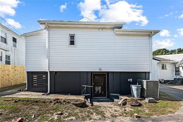 back of house with central air condition unit