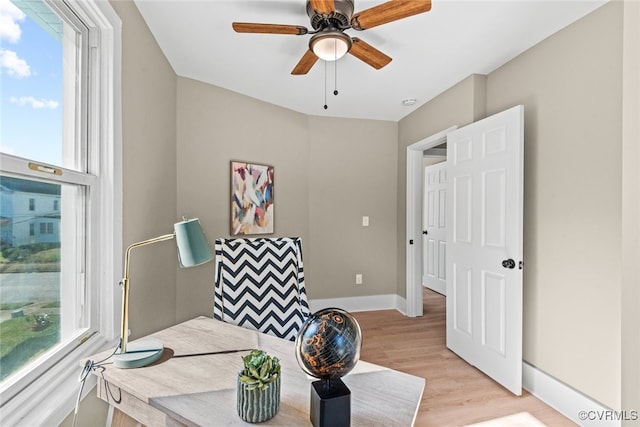 sitting room with plenty of natural light, ceiling fan, and light wood-type flooring