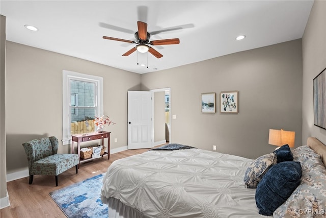 bedroom featuring multiple windows, ceiling fan, and wood-type flooring