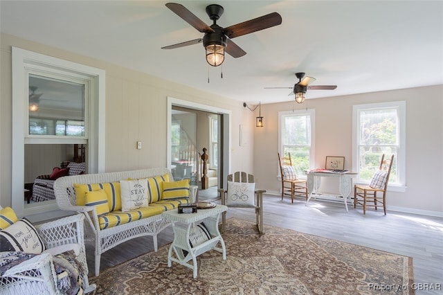 living room featuring hardwood / wood-style floors and ceiling fan