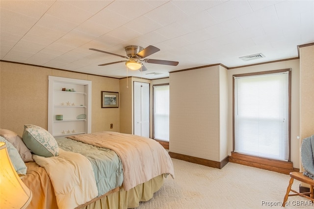 carpeted bedroom featuring multiple windows, ornamental molding, and ceiling fan