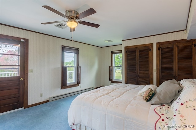 bedroom with ornamental molding, carpet, a baseboard radiator, two closets, and ceiling fan