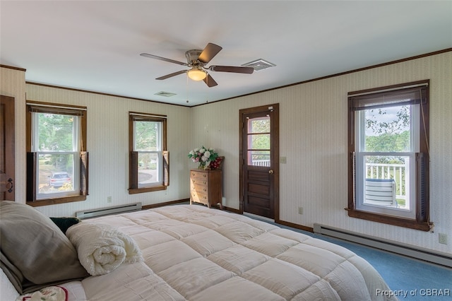 bedroom with ceiling fan, crown molding, and a baseboard heating unit