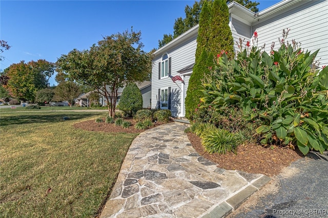 view of side of home with a lawn