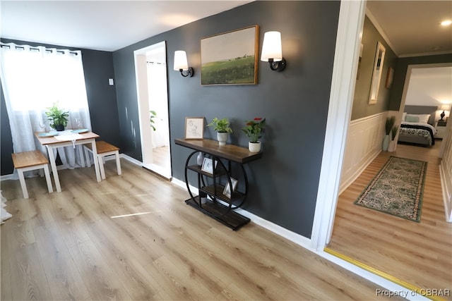 interior space with ornamental molding and light hardwood / wood-style flooring