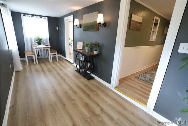 entrance foyer featuring light hardwood / wood-style floors and ornamental molding