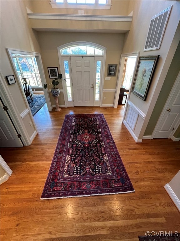 foyer entrance with a high ceiling and light wood-type flooring